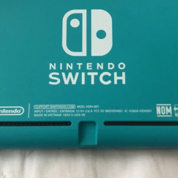 Nintendo Switch Lite with 3 games, 3 characters for Animal Crossing, and case.